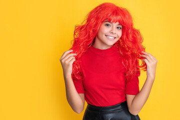 smiling kid with red long hair on yellow background
