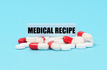 On the blue surface of the pills, capsules and a plate with the inscription - MEDICAL RECIPE