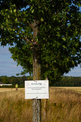 Warning sign in german letters showing to be causious because of oak processionary moths
