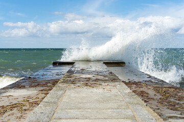 The waves are pounding high on the pier, on the Baltic Sea
