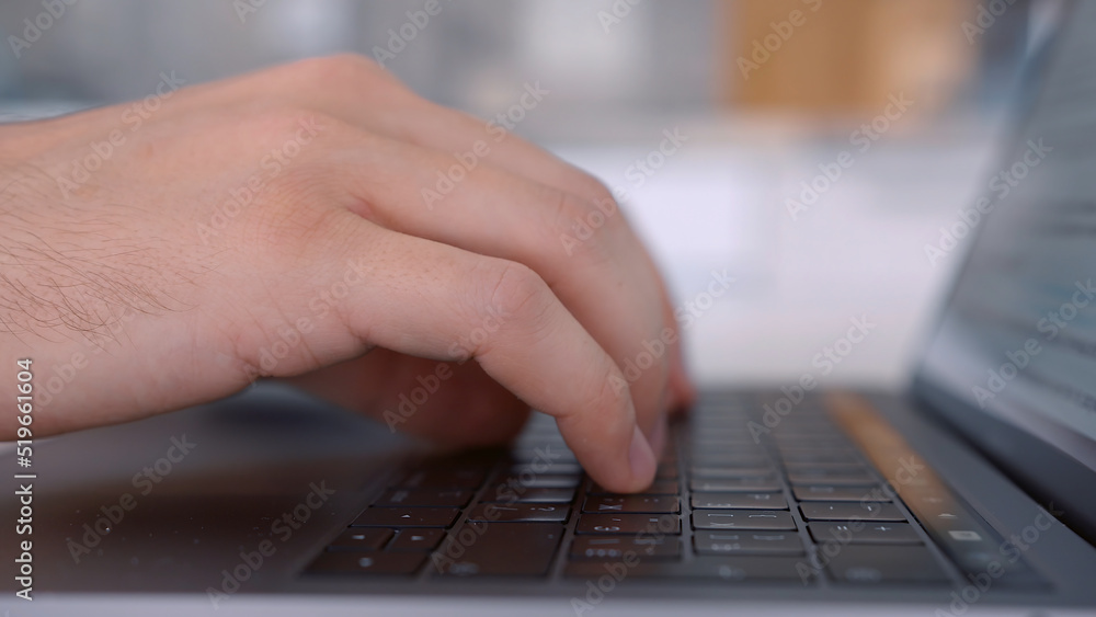 Poster side view of hands pressing keys of black laptop keypad. action. close up of a keayboard and man han