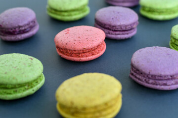 Fototapeta na wymiar Close up of colorful macaroons on grey background. Selective focus.