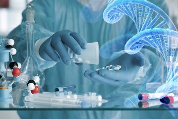 Scientist with tube and virtual screen with data scientific at genetic engineering lab. Biomedical engineer genetic working with tubes in biotechnical laboratory