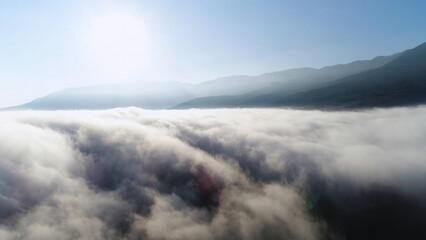Beautiful sunrise above the clouds, view from the top of the mountain. Shot. Aerial for slow...