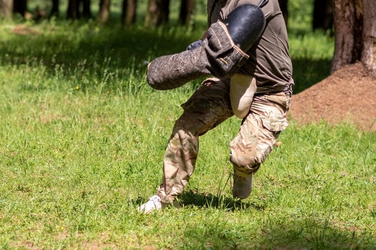 Cynologist with a sleeve for training aggression of dogs.