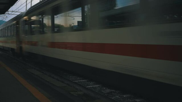 High-speed train passing by the train station.