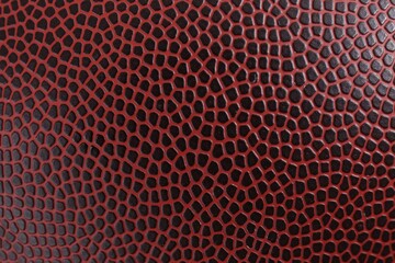 Texture of American football ball leather as background, closeup