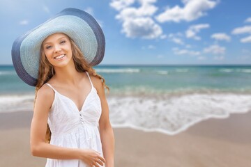 Portrait of a woman wearing a hat enjoying the sun against the blue sea. Summer, vacation, vacation, active retirees