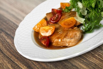 Sweet and sour pork of traditional gourmet cuisine meal food dish on the white serving plate