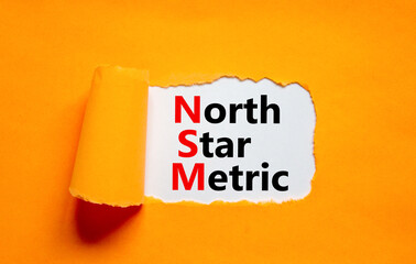 NSM north star metric symbol. Concept words NSM north star metric on white paper on a beautiful...