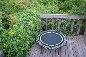 mini trampoline for fitness exercising and rebounding in a backyard patio