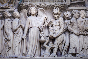 Fototapeta na wymiar Archangel Michael and Satan Last Judgment, Notre Dame of Paris detais