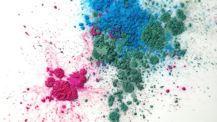 Fototapeta na wymiar Top view of dry colorful inks falling in white liquid substance. Beautiful iridescent background of green, blue and rose powder in white fluid.