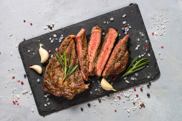Beef steak striploin on cutting board. Fresh beef steak uncooked meat with ingredients for cooking....
