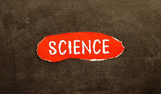 The word SCIENCE written in red on a black and white background near the pen.