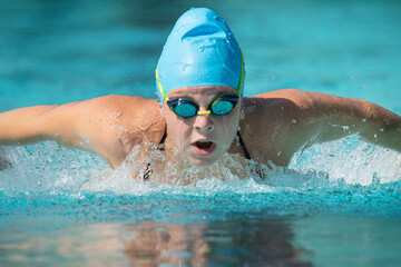 Female teenage swimmer doing butterfly