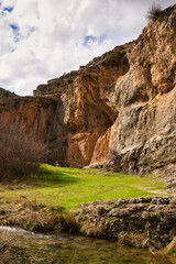 Green grass meadow below a canyon