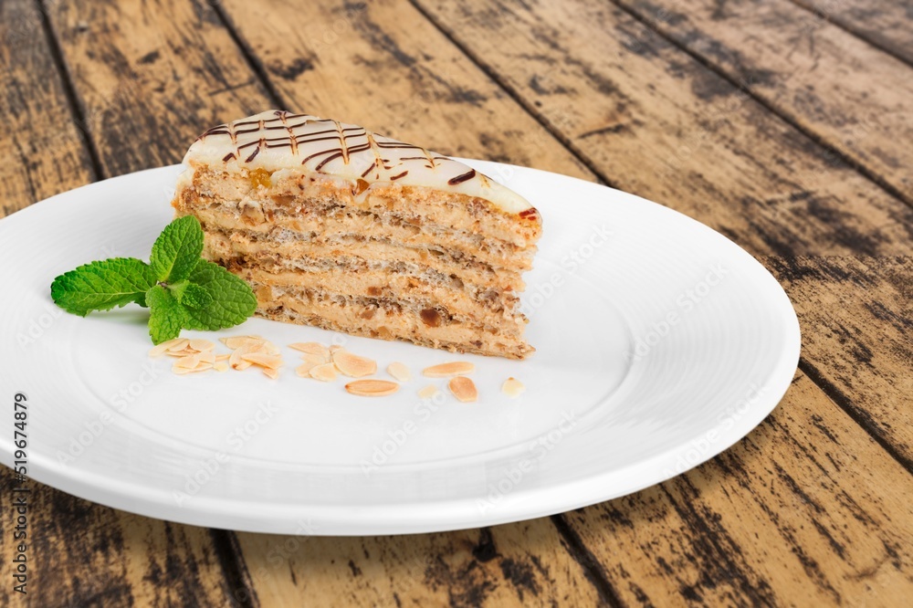 Poster Tasty sweet cake on white ceramic plate. Popular dessert in minimal style