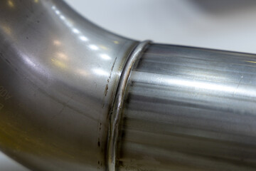 Weld seam on a steel pipe close-up. Laser welding of metal. High quality work