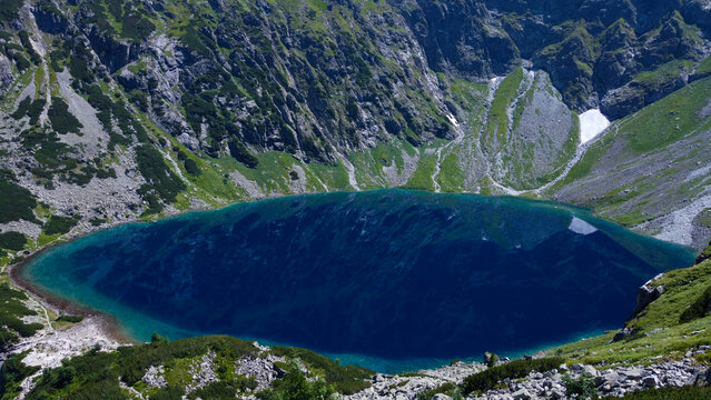 Blue water of the Czarny Staw pod Rysami or the Black Pond in Polish Tatry Mountains near Zakopane, Poland