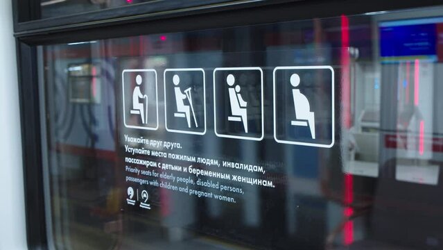 Informative stickers in both russian and english inside the subway train. warning instruction on the window of metro wagon.