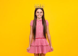 Teen child in queen crown isolated on yellow background. Princess girl in tiara. Teenage girl wear diadem.