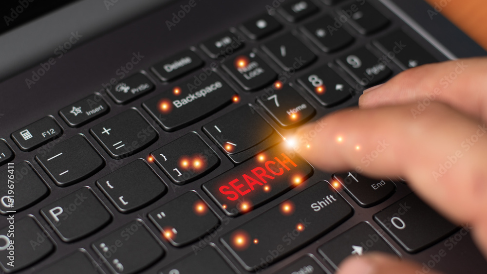 Fototapete a hand hit on the search keyboard button, searching technology online concept. computer graphic ligh