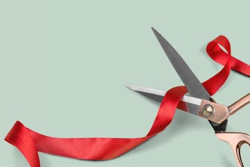 Grand opening with red ribbon and scissors. Cut a red ribbon on a light background.