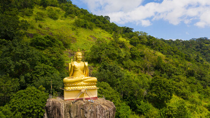 Buddha statue at a hill slope near Aluvihare Rock Temple. Aluvihara Rock Temple, Matale Sri Lanka.
