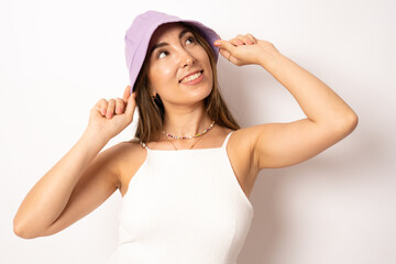 Young smiling woman wearing summer hat looking away standing isolated over white background.