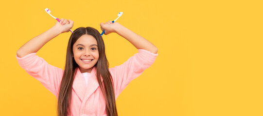 funny teen girl hold toothbrush. childhood happiness. morning routine. Banner of child girl with teeth brush, studio portrait, header with copy space.