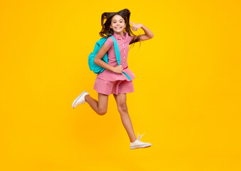 School teen girl in with backpack. Teenager student on isolated background. Crazy run and jump. Kids learning, education, studying and knowledge.