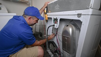 Appliance Technician Cleaning an Electric Dryer