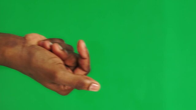 Set of 16 gestures made by African American man on chroma key background filmed in closeup. Black male hand on green screen is showing various signs. He makes thumb up and clapping. Snap by fingers