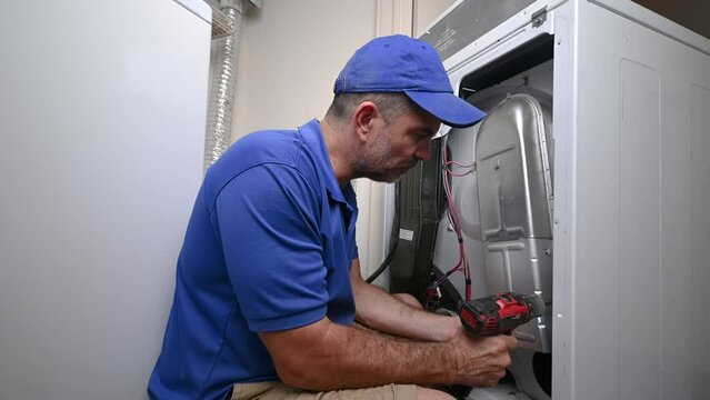 Appliance Technician Removing Heating Element on Dryer