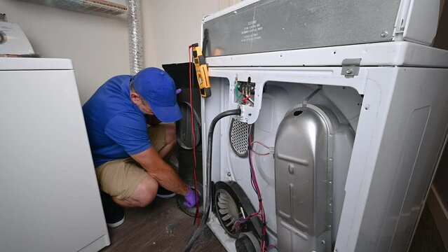 Appliance Technician Cleaning Out a Dryer Chute