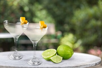 Two glasses with fresh homemade cocktail on a table at summer evening,