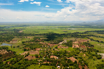 Fototapeta na wymiar Aerial view of agricultural land and farm fields with crops in the valley. Rural landscape. Sri Lanka.