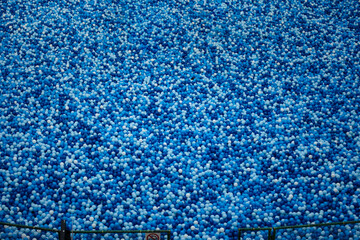Many plastic balls in swimming pool. A lot of plastic balls. Small plastic balls in large quantity.