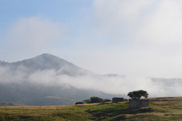 Obraz premium abandoned house on a hill, unfinished building, with mountains