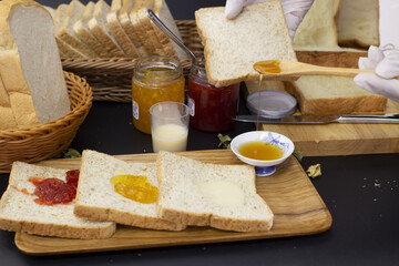 chef preparing breakfast Bread topped with honey, orange jam, strawberry jam