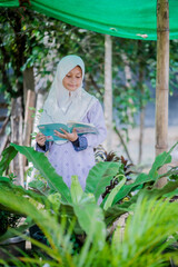  muslim girl homework in the garden