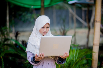  muslim girl homework in the garden
