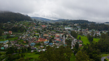 The town of Nuwara Eliya is covered with clouds among green hills and mountains. Sri Lanka.