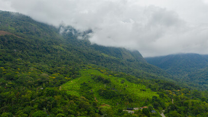 Top view of Mountain slopes with rainforest and agricultural land of farmers. Sri Lanka.