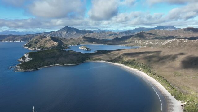 national park aerial footage of a ocean bay with a yacht below