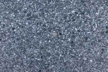Asphalt texture - top view and close-up of a fragment of an old asphalt road