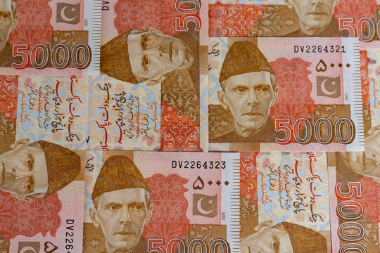 Pakistani five thousand rupees banknotes arranged in a pattern texture or background