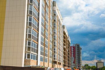 The architectural complex of residential buildings on sky background