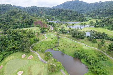 Aerial view drone shot of beautiful green golf field fairway and putting green Top down image for...